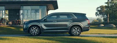 2020-Hyundai-Palisade-exterior-side-shot-parked-outside-a-luxury-home-on-a-concrete-strip-bet...webp